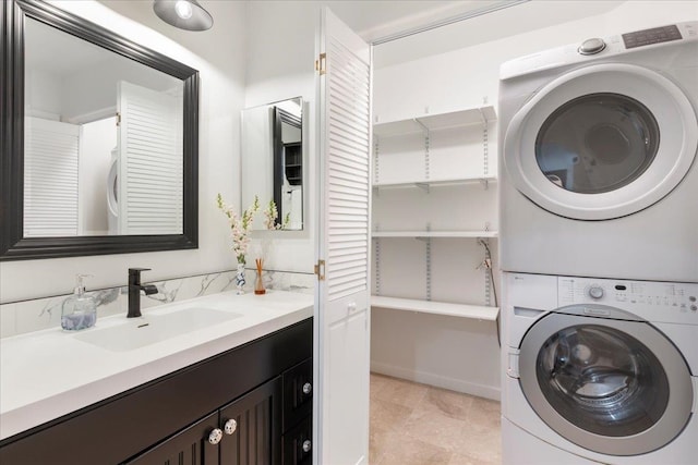 clothes washing area featuring light tile floors, sink, and stacked washer and clothes dryer