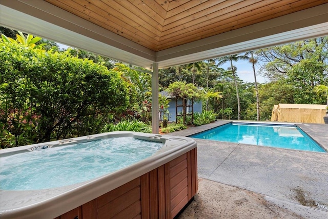 view of swimming pool with an outdoor hot tub and a patio