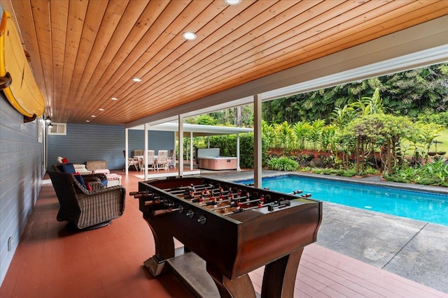 recreation room with hardwood / wood-style floors and wood ceiling