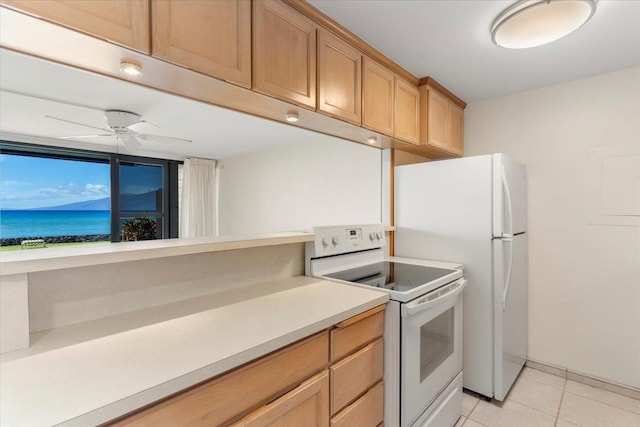 kitchen featuring white appliances, light tile patterned floors, and ceiling fan