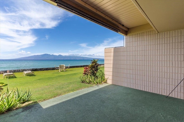 exterior space with a water and mountain view