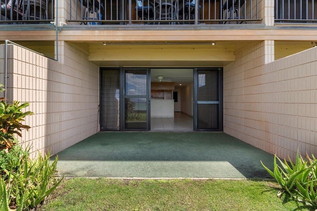 doorway to property with a balcony and a patio