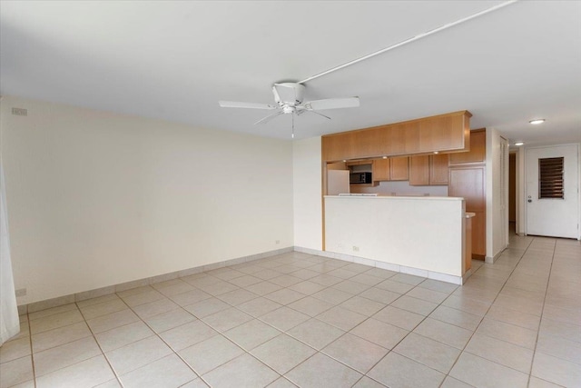 interior space with ceiling fan and light tile patterned floors