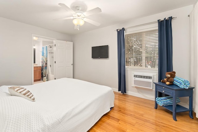 40 Halili Ln Unit 4D, Kihei, HI 96753 - bedroom with a wall unit AC, light wood-style floors, ceiling fan, and ensuite bath