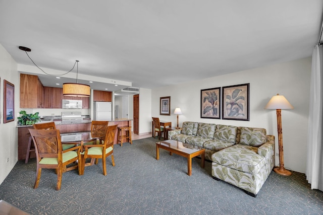 living room with dark carpet and recessed lighting