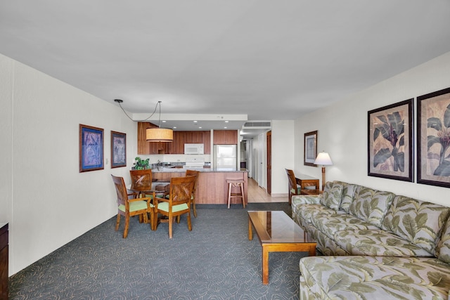 living room with dark colored carpet