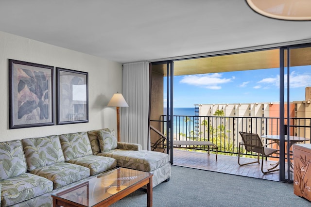 living room featuring expansive windows, carpet floors, and a water view