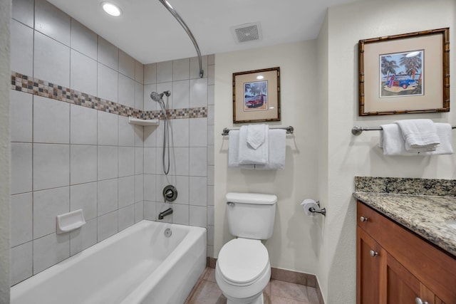 bathroom with baseboards, tile patterned floors, toilet, vanity, and shower / washtub combination