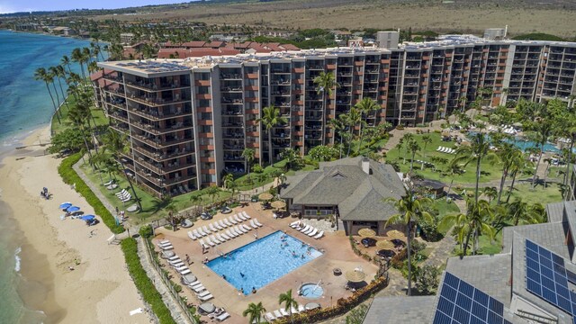 aerial view of apartment complex / building, a large body of water, and a pool area