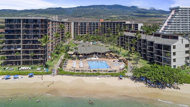 bird's eye view of apartment complex / building, a water and mountain view, and a pool
