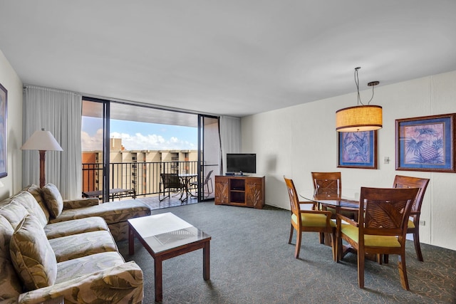 carpeted living area featuring floor to ceiling windows
