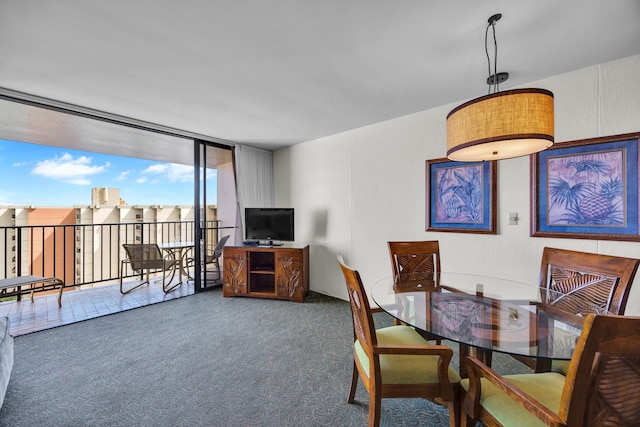 carpeted dining space featuring floor to ceiling windows