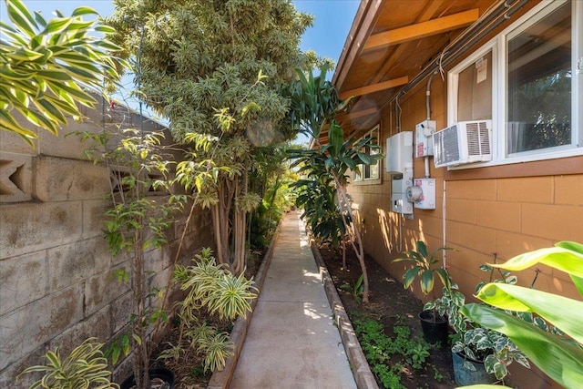 view of home's exterior featuring concrete block siding and fence