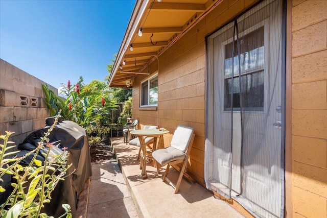 view of patio featuring fence and area for grilling