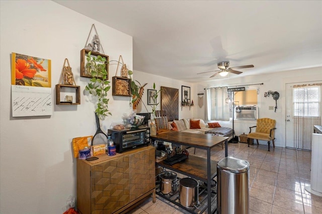 interior space featuring cooling unit, a toaster, ceiling fan, and light tile patterned floors