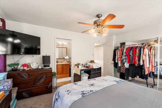 carpeted bedroom with connected bathroom, a closet, and ceiling fan