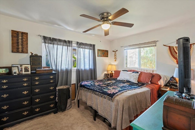 bedroom with light carpet and a ceiling fan