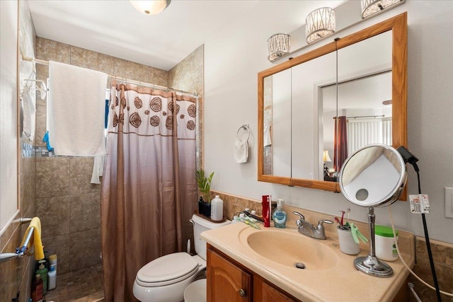 bathroom featuring toilet, tile walls, tiled shower, and vanity