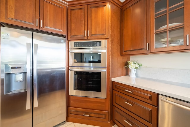 kitchen with light stone countertops and stainless steel appliances