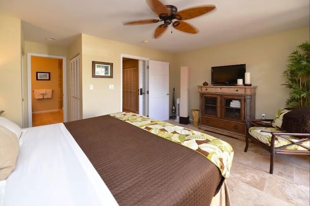 bedroom featuring ceiling fan, a closet, and ensuite bath