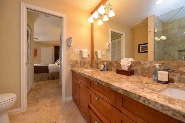 bathroom with walk in shower, vanity, and toilet