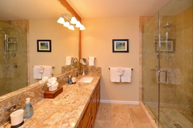 bathroom with vanity and a shower with door