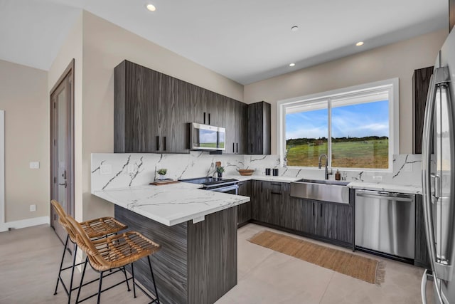 500 Kai Huki Cir Unit B, Haiku, HI 96708 - kitchen with stainless steel appliances, a peninsula, a sink, a breakfast bar, and backsplash