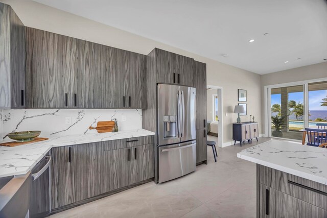 500 Kai Huki Cir Unit B, Haiku, HI 96708 - kitchen with appliances with stainless steel finishes, tasteful backsplash, modern cabinets, recessed lighting, and light stone countertops