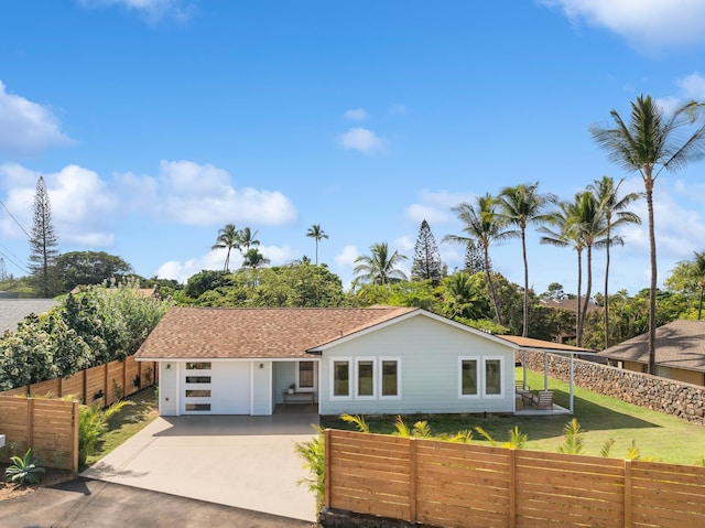 view of front facade with a front yard and a garage