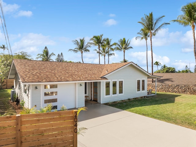 ranch-style home with a front lawn and a garage