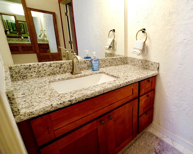 bathroom featuring tile patterned flooring and vanity