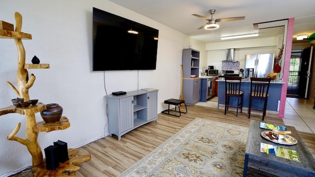 living room featuring ceiling fan and light hardwood / wood-style flooring