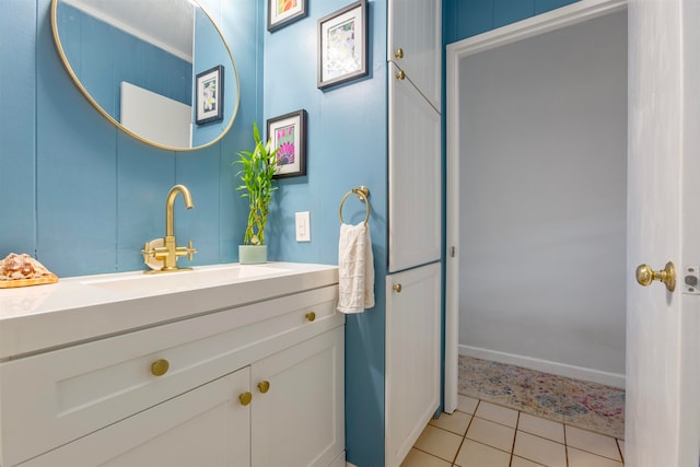 bathroom with vanity, baseboards, and tile patterned floors