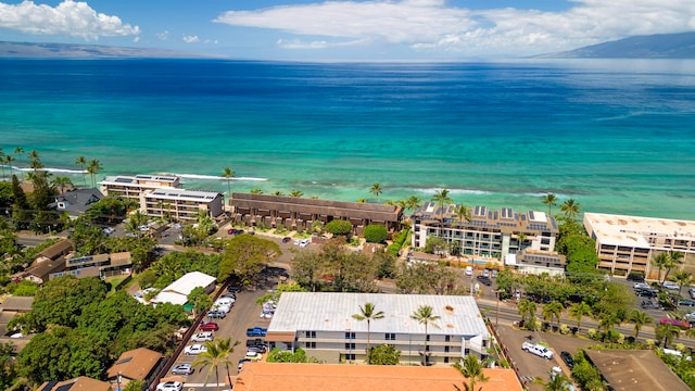 birds eye view of property featuring a water view and a beach view