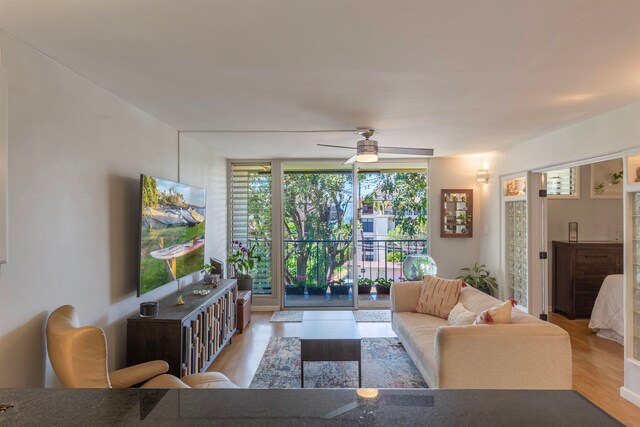 living room featuring ceiling fan and wood finished floors