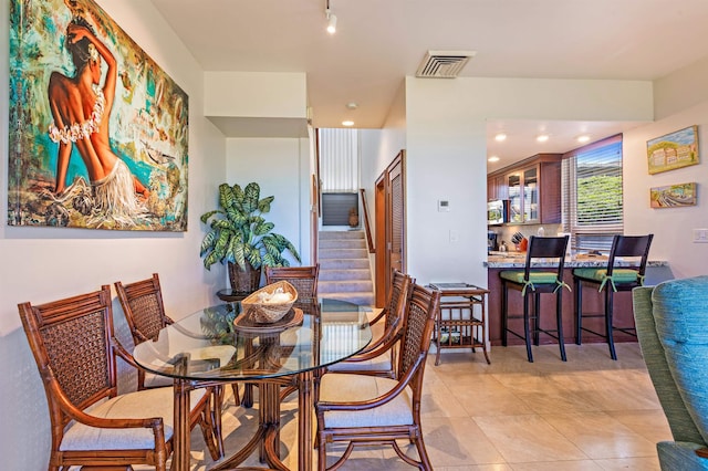 dining area featuring visible vents, light tile patterned flooring, recessed lighting, stairs, and track lighting