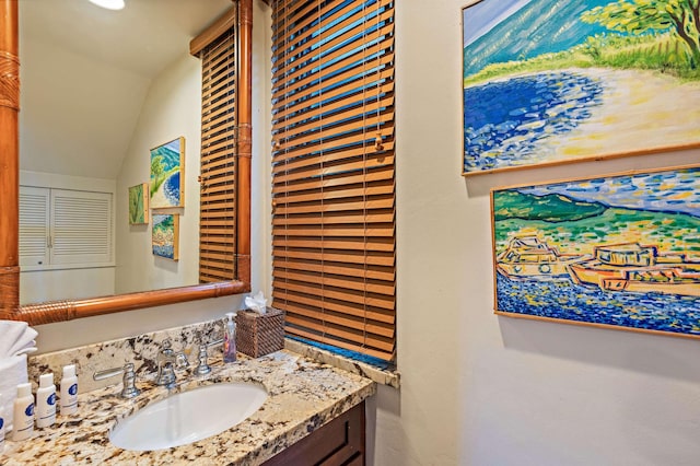 bathroom featuring vanity and vaulted ceiling