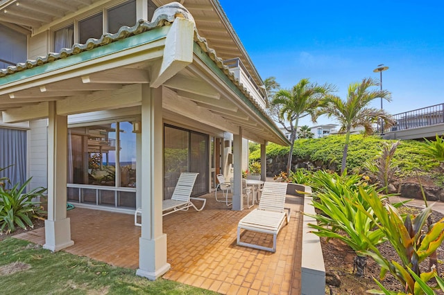 view of patio with a sunroom