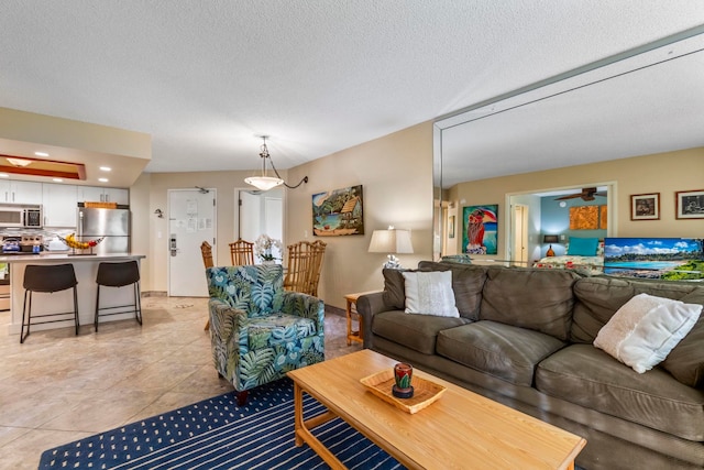 living room featuring light tile patterned floors and a textured ceiling