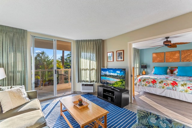 bedroom with ceiling fan, a textured ceiling, and access to outside