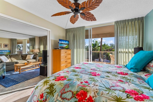 bedroom with a textured ceiling, access to outside, and ceiling fan