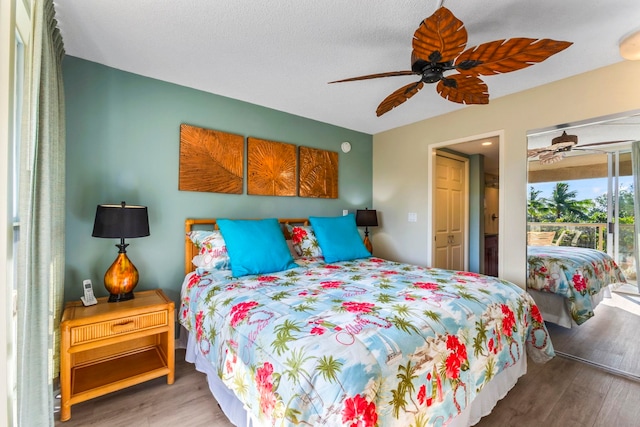 bedroom with hardwood / wood-style floors, access to exterior, and ceiling fan