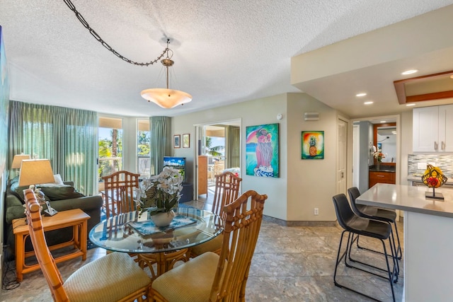 dining room with a textured ceiling