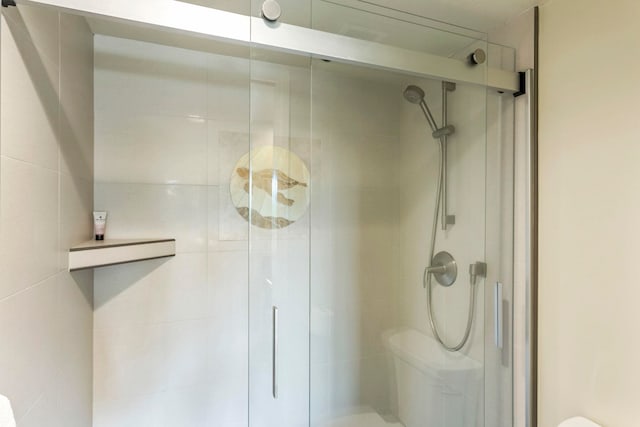 bathroom with a shower with shower door