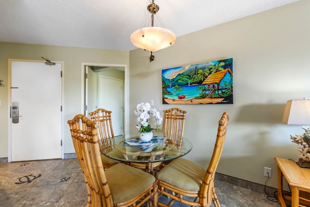 dining room featuring a textured ceiling