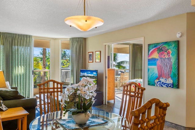 dining space featuring tile patterned flooring and a textured ceiling