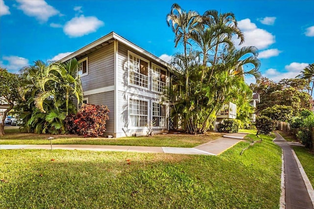 view of home's exterior featuring a lawn