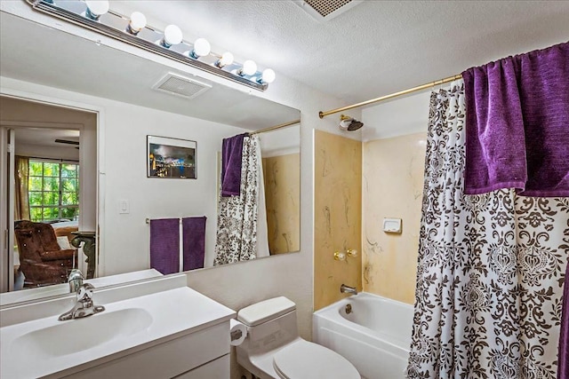 full bathroom featuring vanity, toilet, shower / bath combo with shower curtain, and a textured ceiling