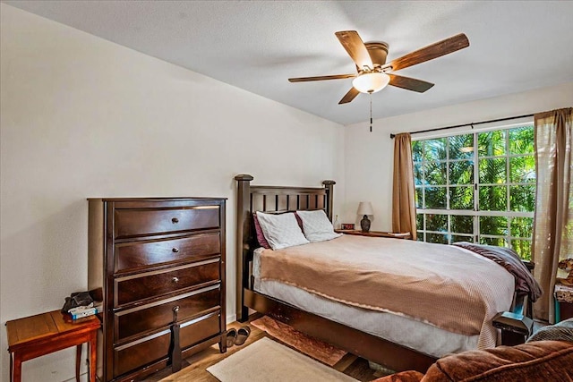 bedroom with ceiling fan and light wood-type flooring