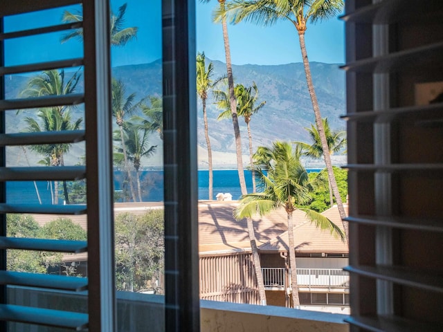 doorway to outside with a water and mountain view